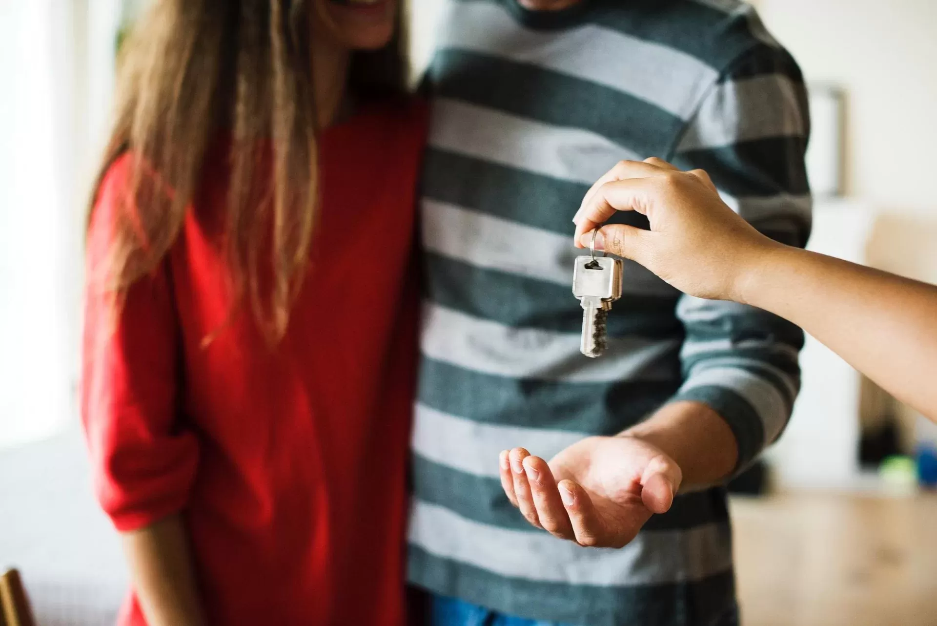 A couple being handed the keys to their new home.
